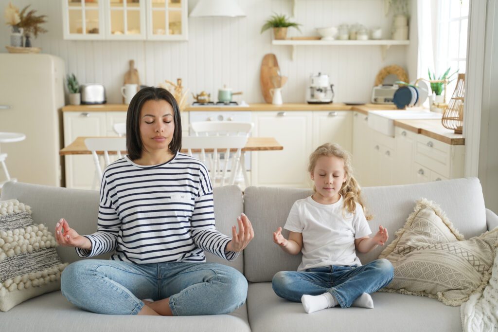 Mother and little Daughter Practice Yoga